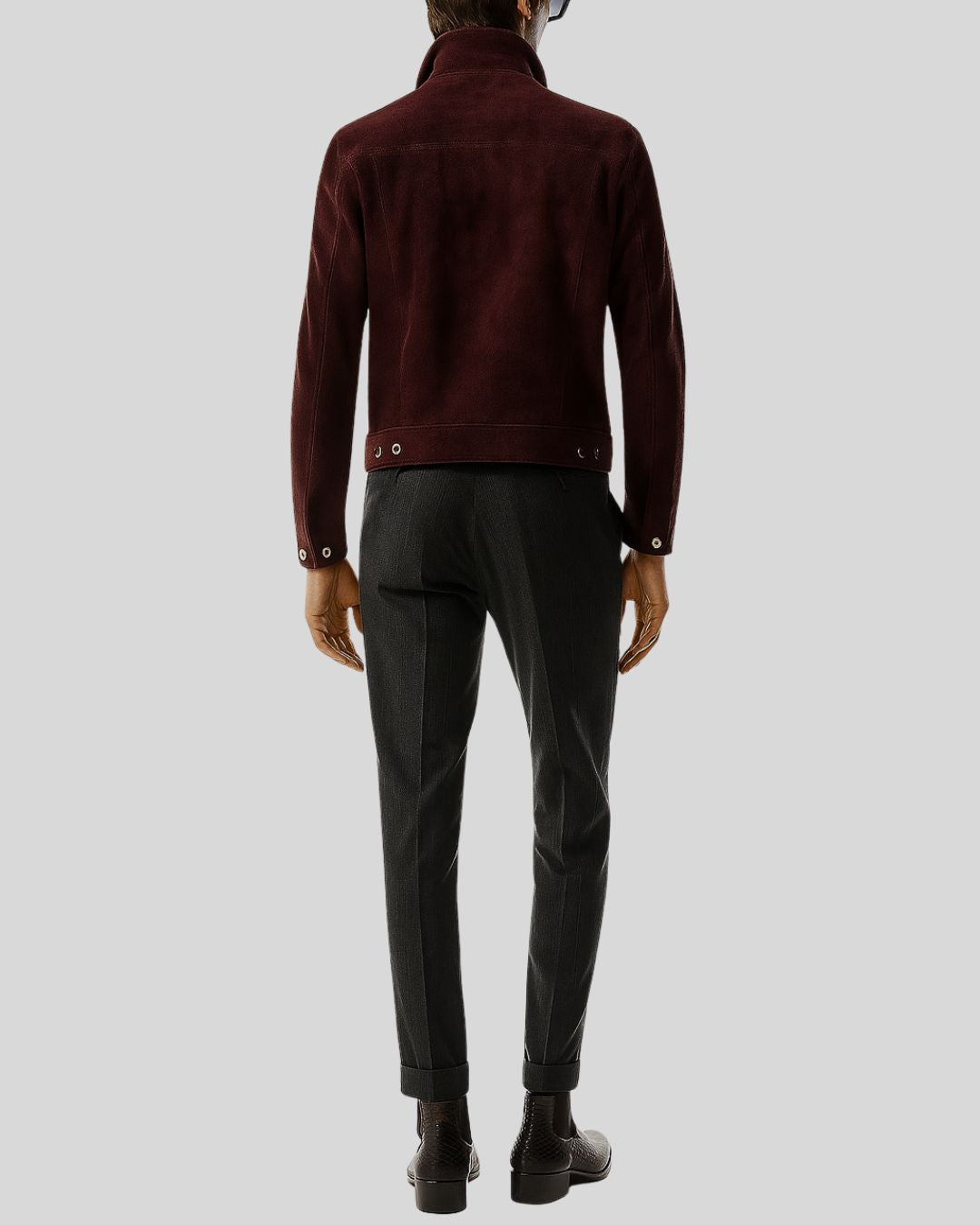 Back View burgundy jacket and dark pants on a light gray background