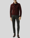 Man wearing men’s burgundy suede shirt jacket with dress trousers