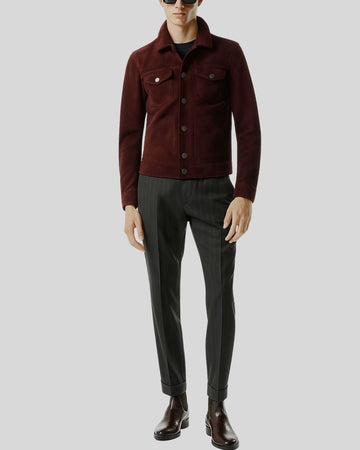 Man wearing men’s burgundy suede shirt jacket with dress trousers