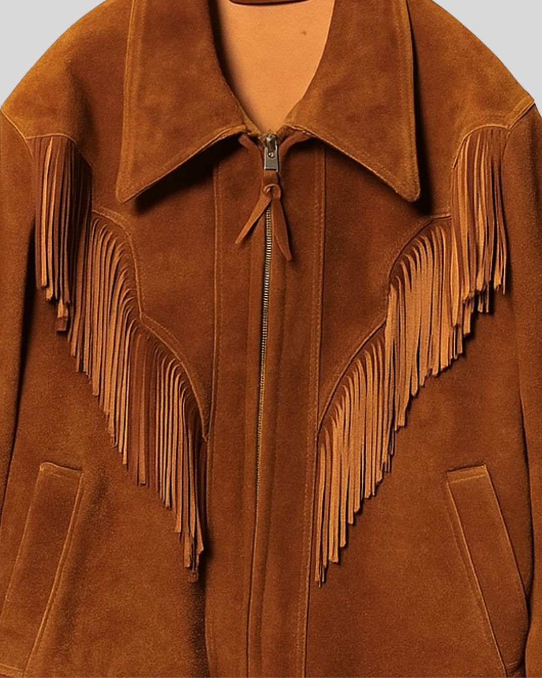 Close-up of chestnut suede fabric and metal zipper on men’s fringe jacket
