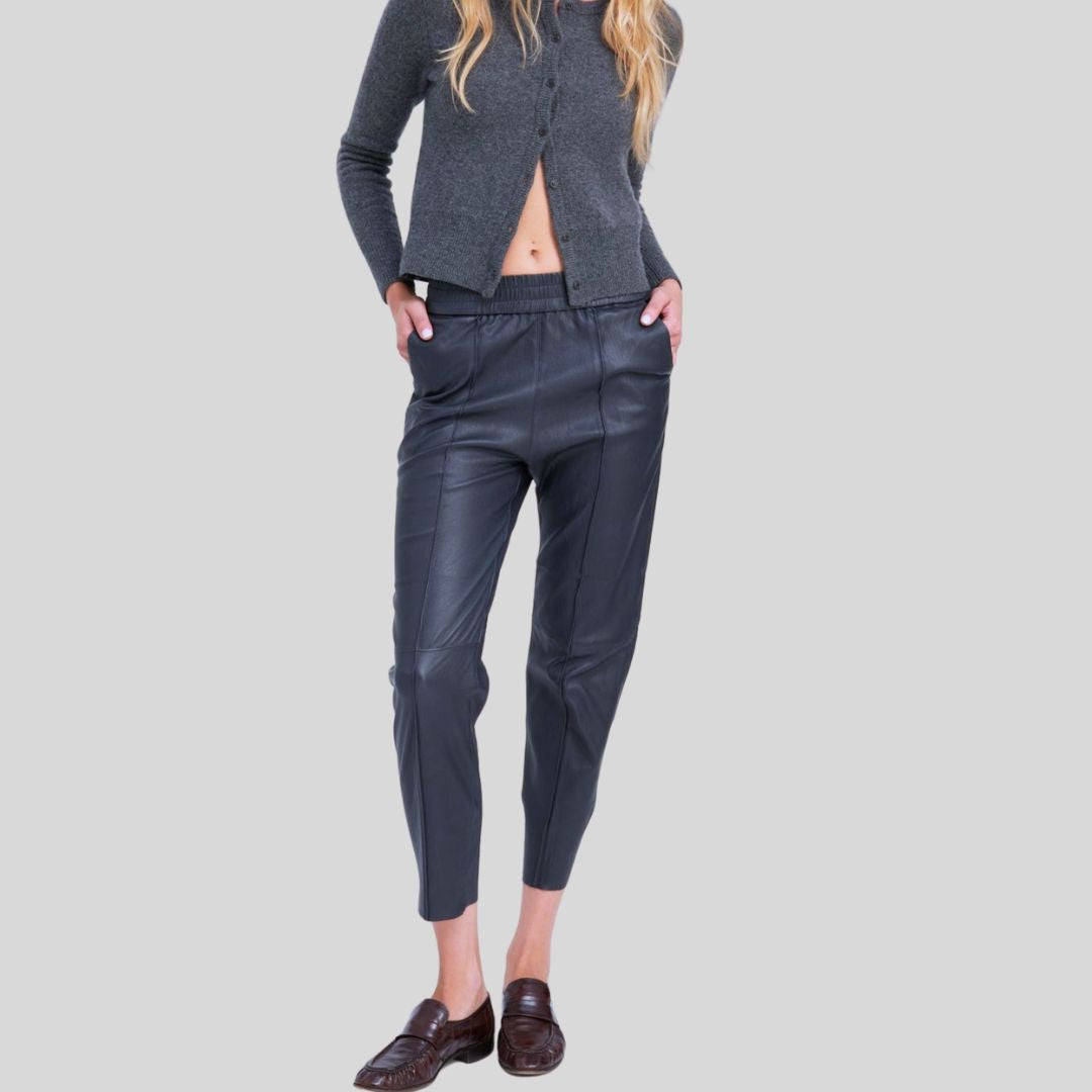 stylish pose wearing Midnight Luxe blue leather skinny joggers