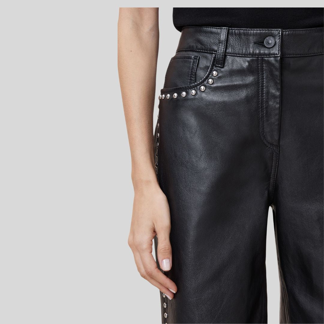 front close-up of black lambskin pants with button and studs