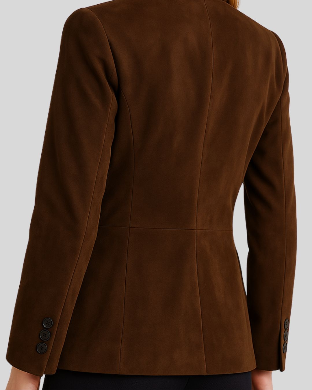 Close-up of brown suede blazer's sleeve and back seam
