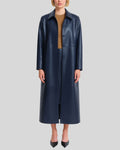 Womens navy blue long leather coat worn open over camel top