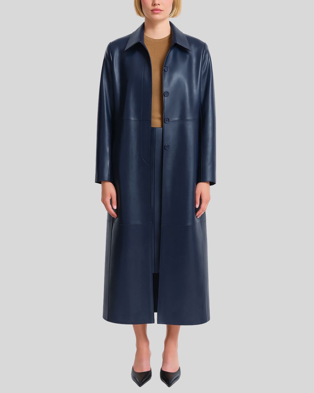 Womens navy blue long leather coat worn open over camel top