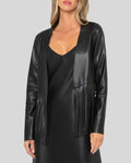 Black leather fringe jacket worn with black slip dress
