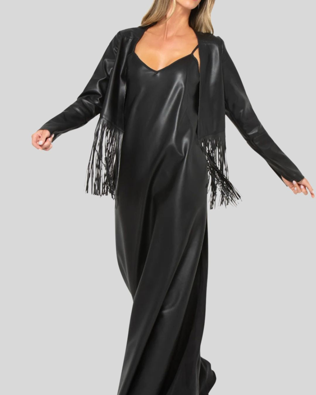 Black leather fringe jacket worn with black slip dress
