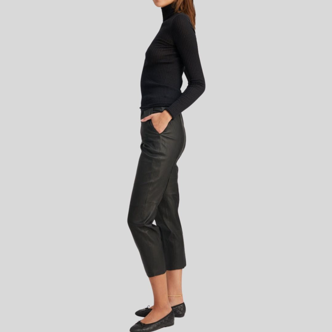 side view of tapered black cropped leather pants