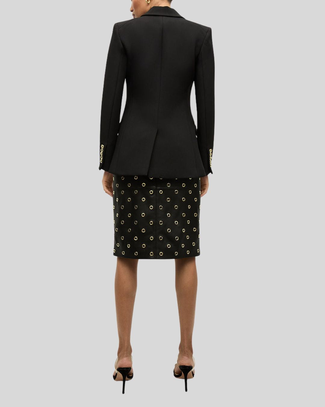 Back view of model in Noir Edge black leather pencil skirt and black blazer