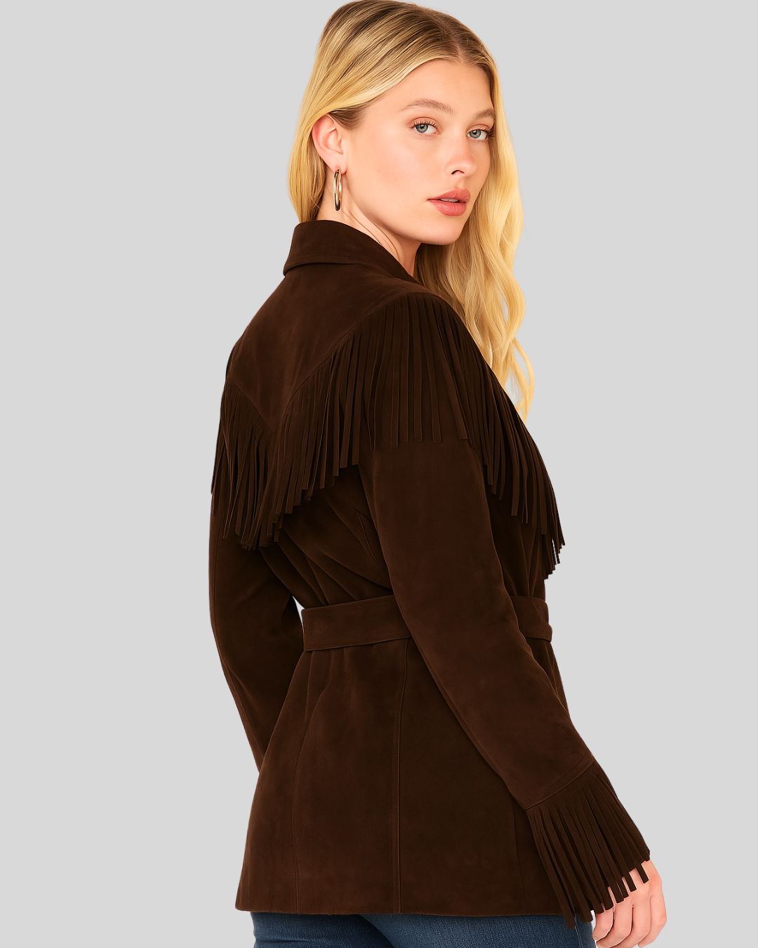  Woman in brown suede fringe belted jacket looking over shoulder
