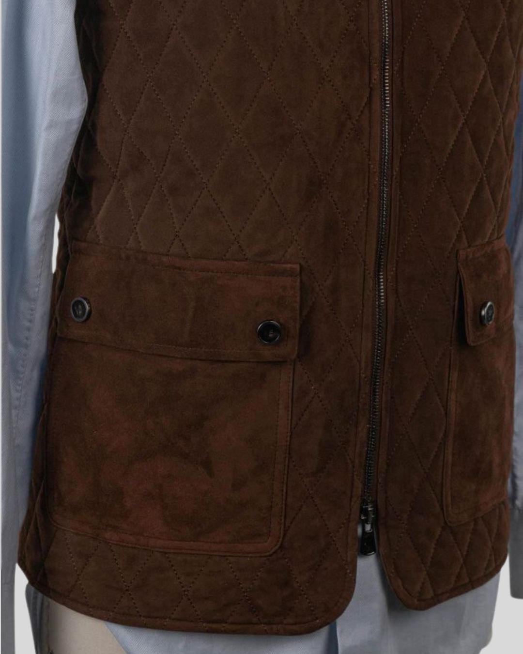 flap pocket detail of men's dark brown suede quilted vest