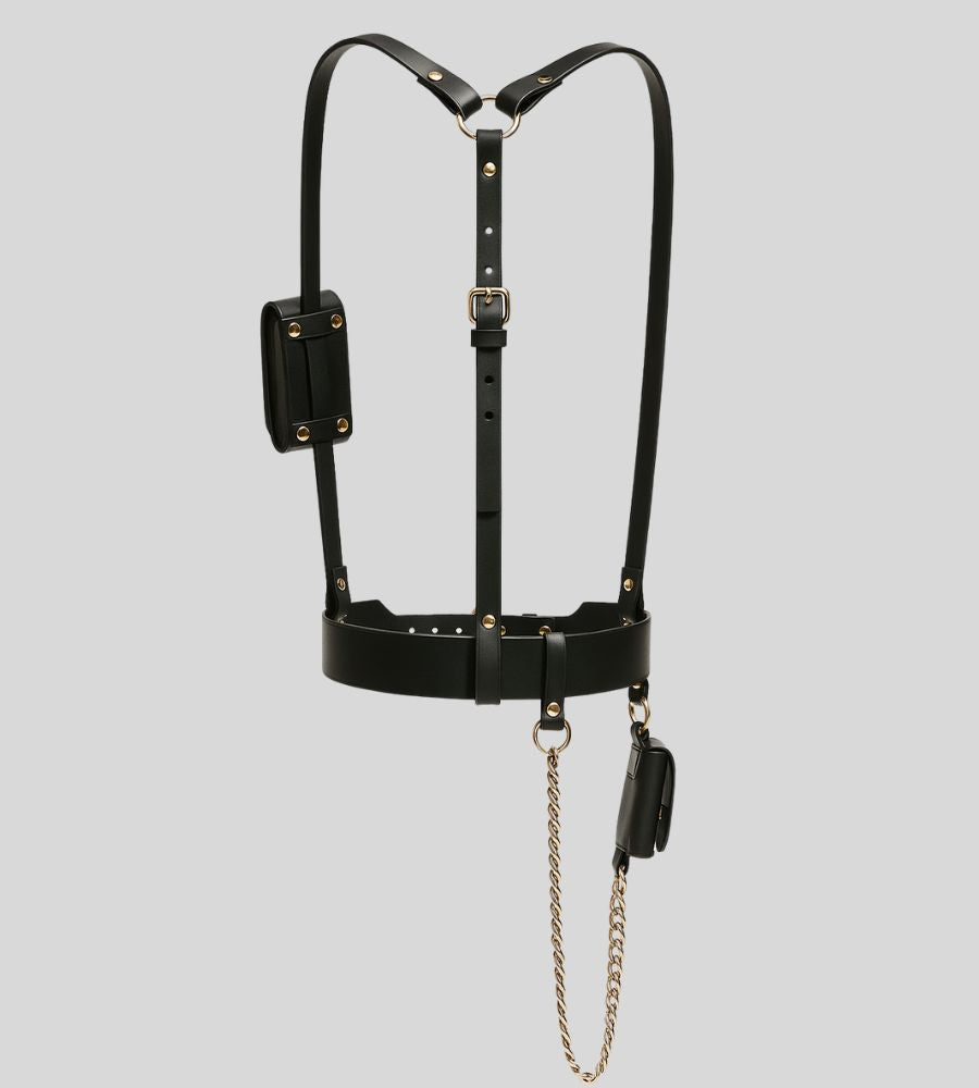 Rear view of black leather harness with utility pouches and chain