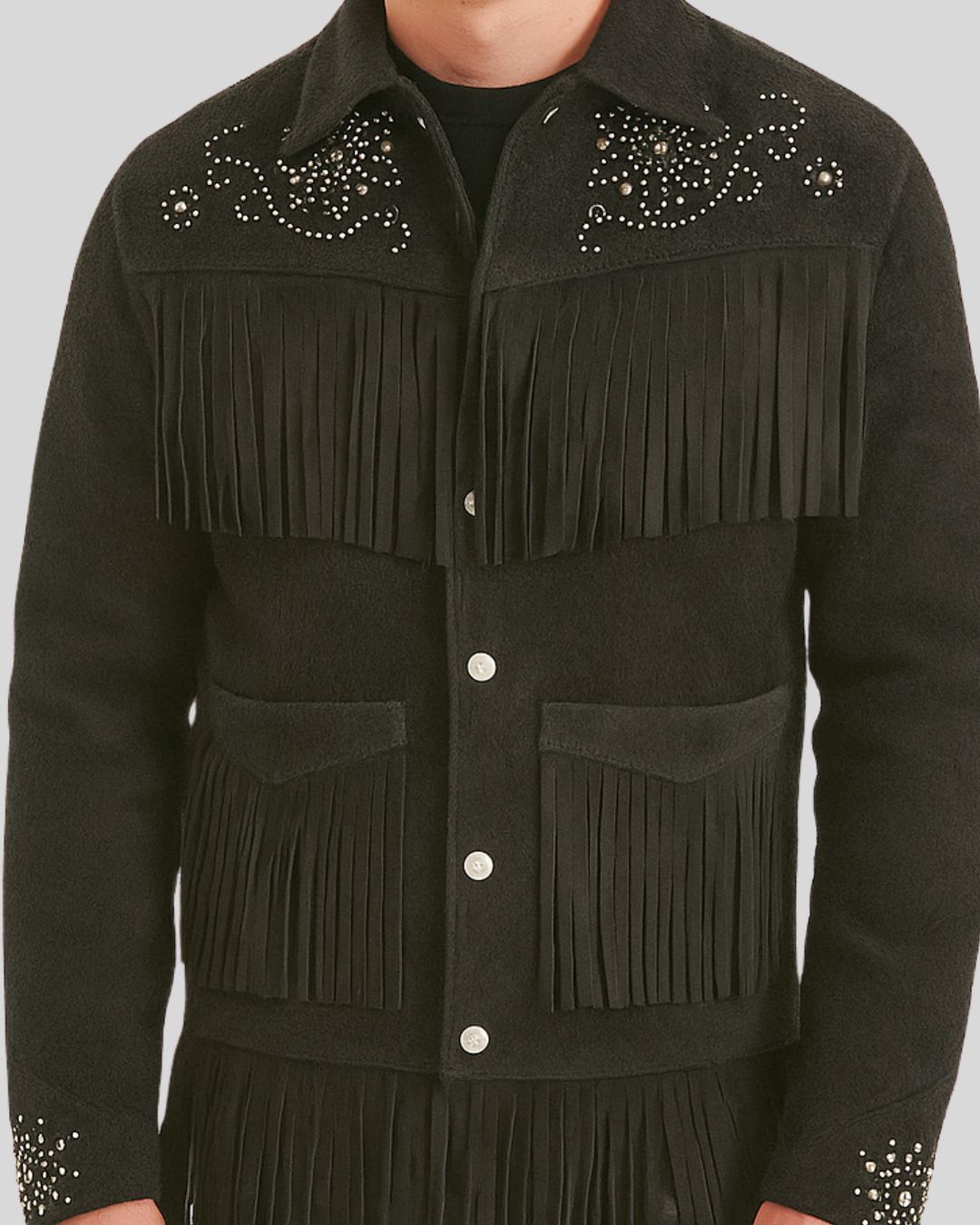 Close-up of rhinestone and fringe detail on black suede jacket