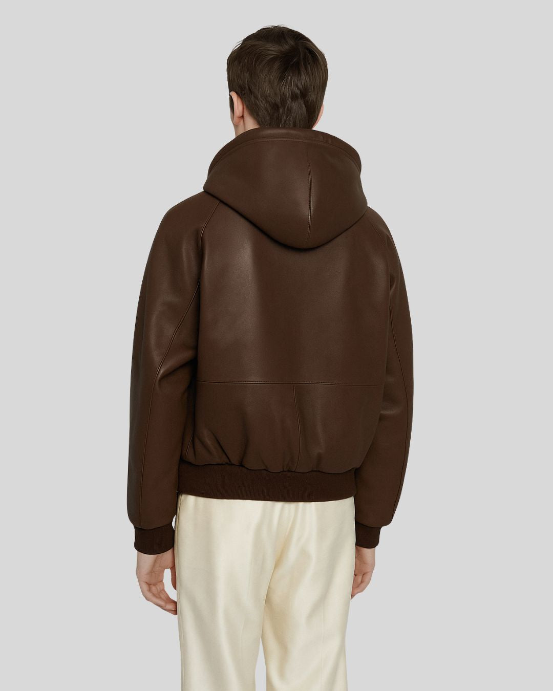 Front view of dark brown leather bomber jacket with hood