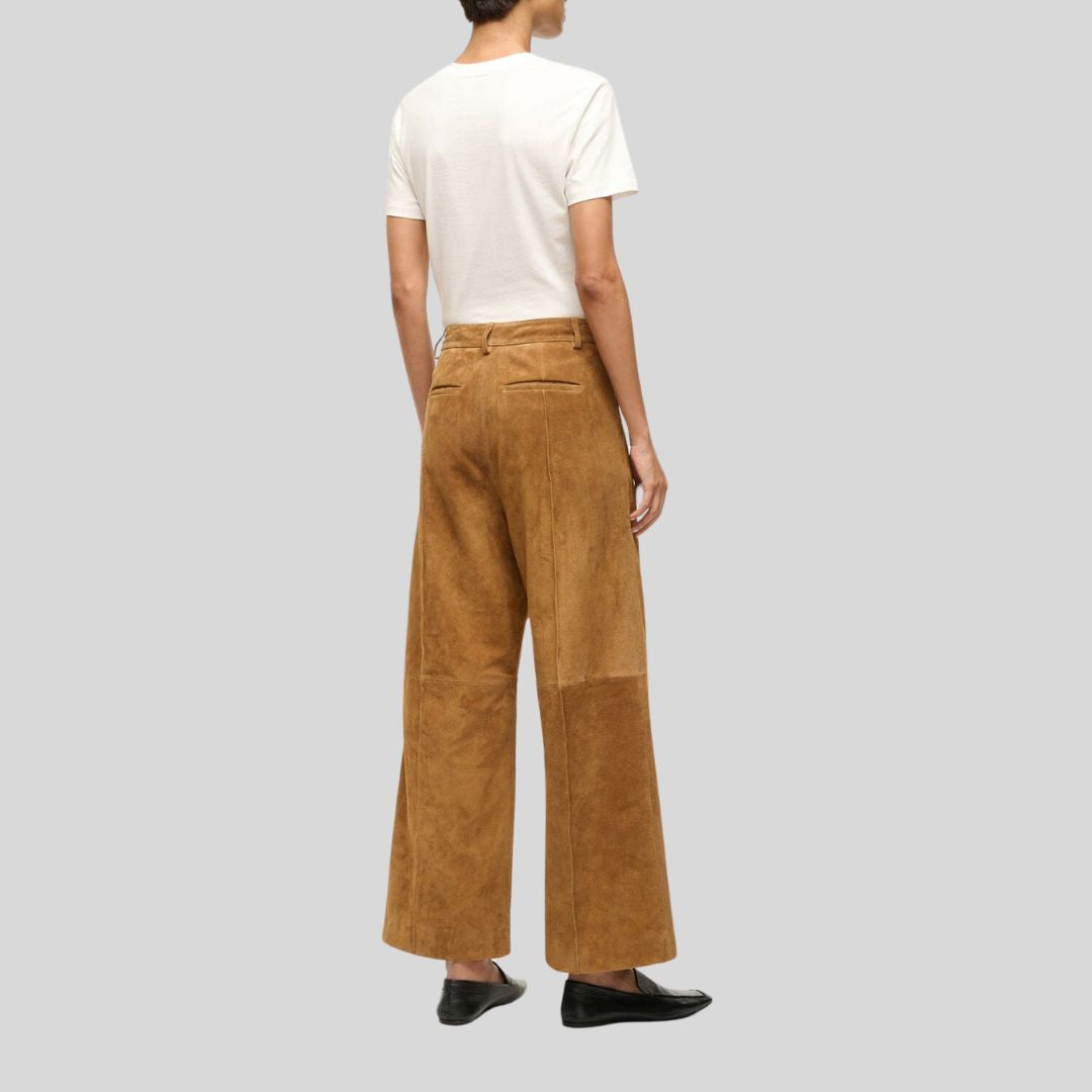 rear view of tan suede wide leg pants with belt loops