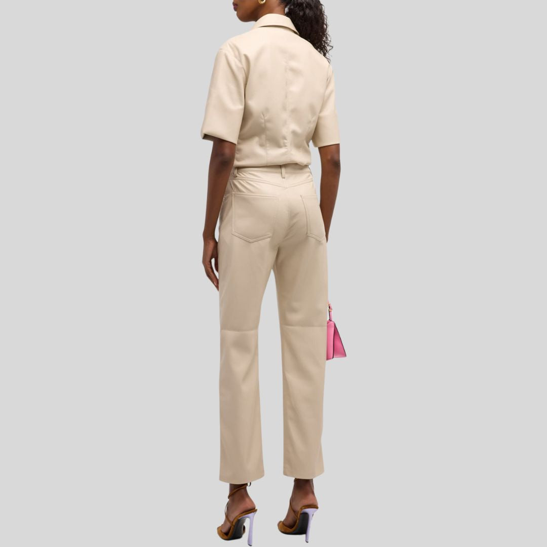  Back view of beige leather pants worn by model with short-sleeve shirt
