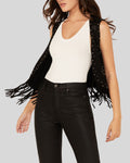 Woman wearing ShadowCrest black suede fringe vest with studded detailing
