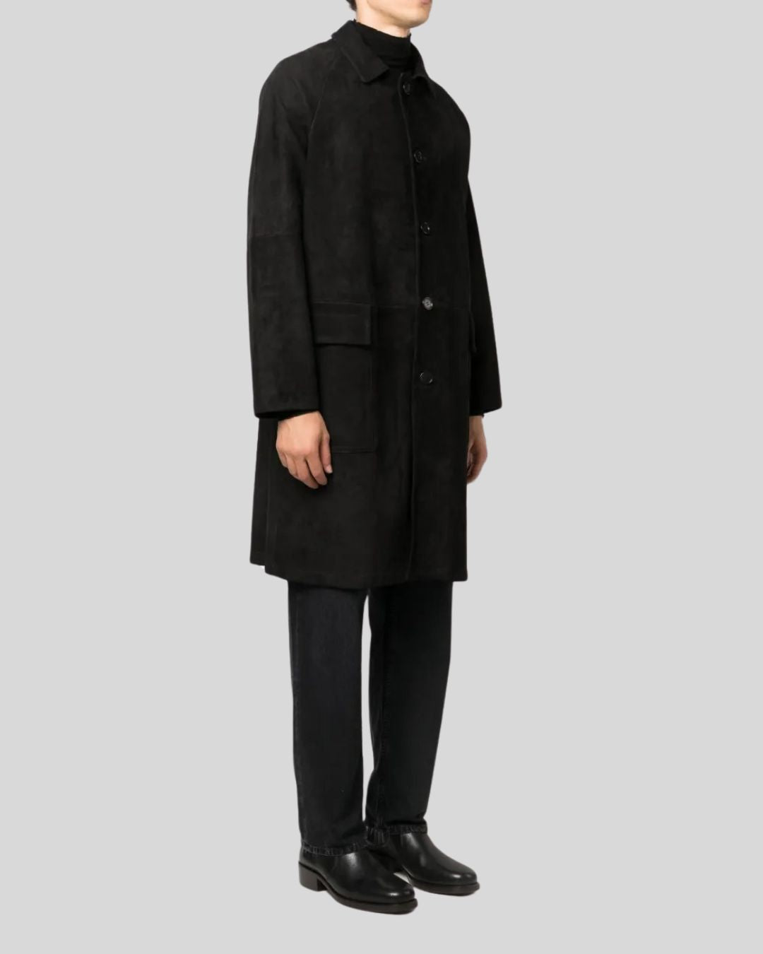 Side profile wearing black suede long coat