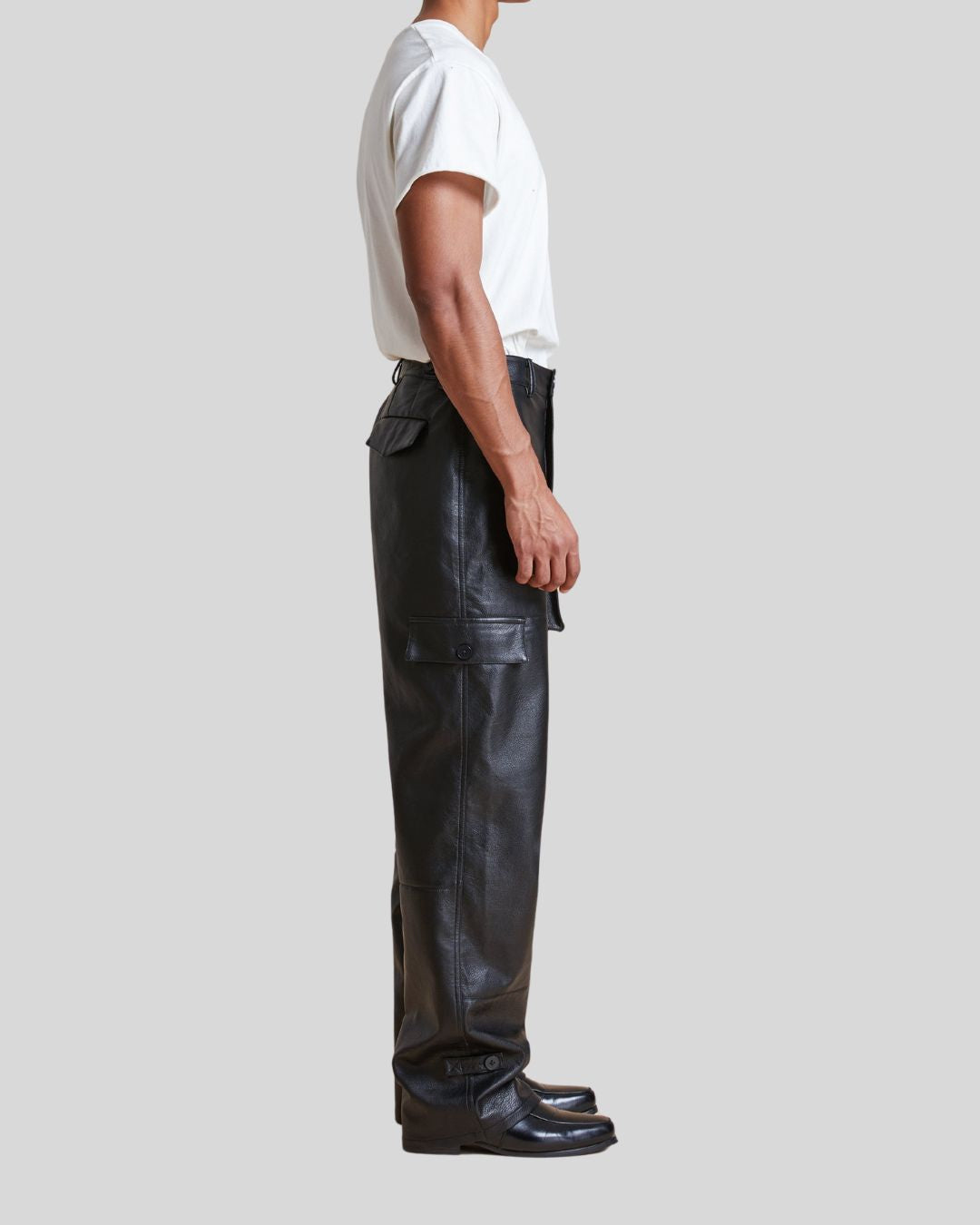 side profile of black leather pants with cargo pockets – Night Ops
