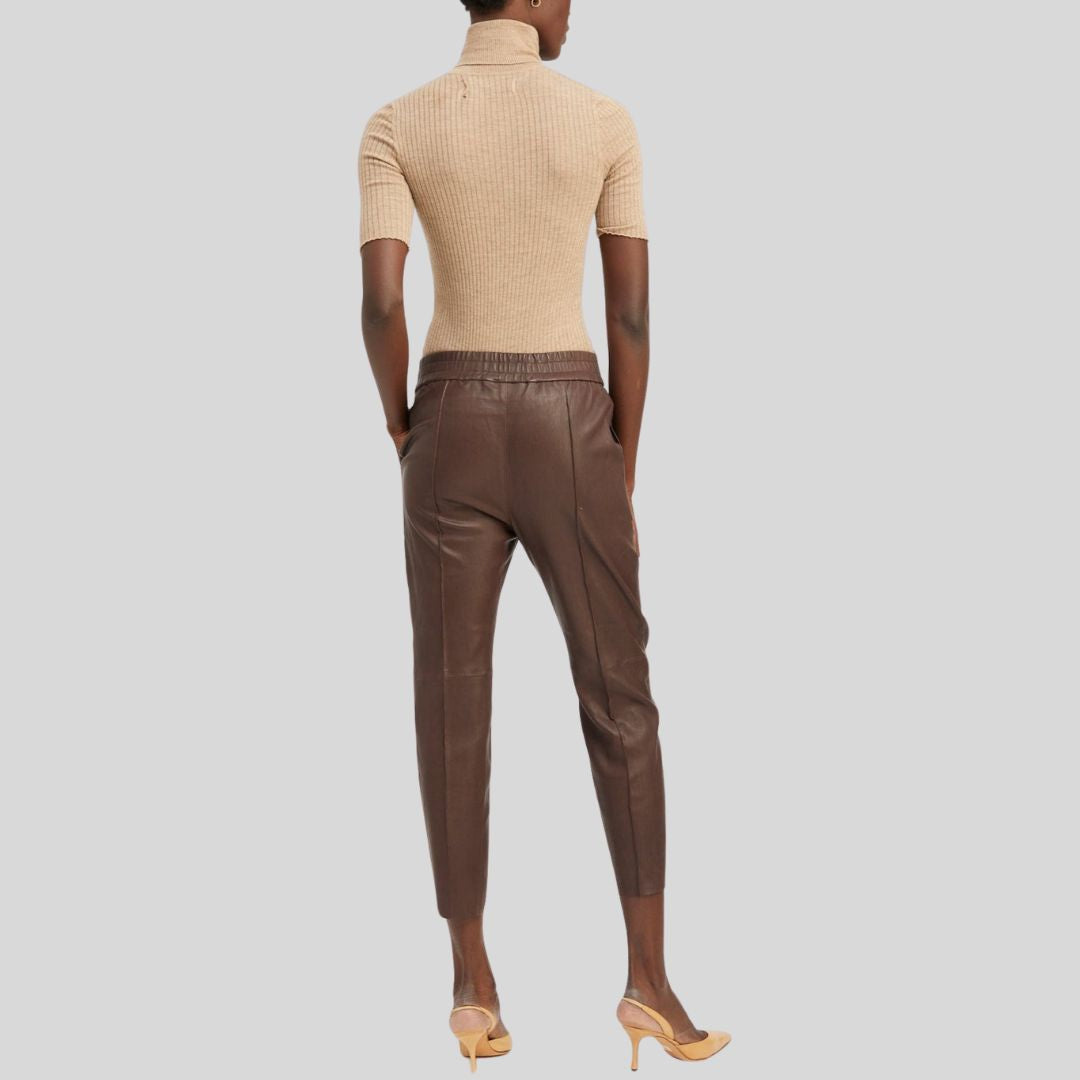 Back view of cropped brown leather pants womens