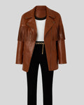  Flat lay of Sierra brown leather fringe jacket with black pants and white top
