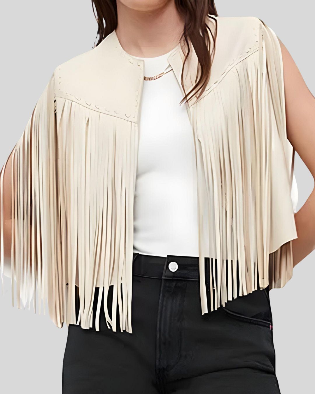  Model wearing cream leather fringe vest with white top and black pants

