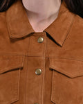  Close-up of collar and brass snap on tan suede fringe jacket
