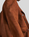 Side sleeve and pocket close-up of brown suede coat