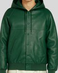 Close-up of green leather hoodie jacket’s snap buttons and pocket seams