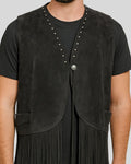 Close-up of studs and concho button on black suede western vest