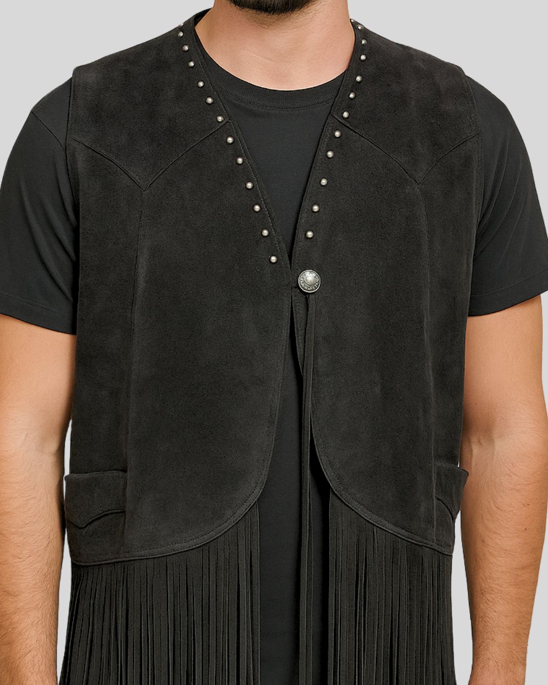 Close-up of studs and concho button on black suede western vest