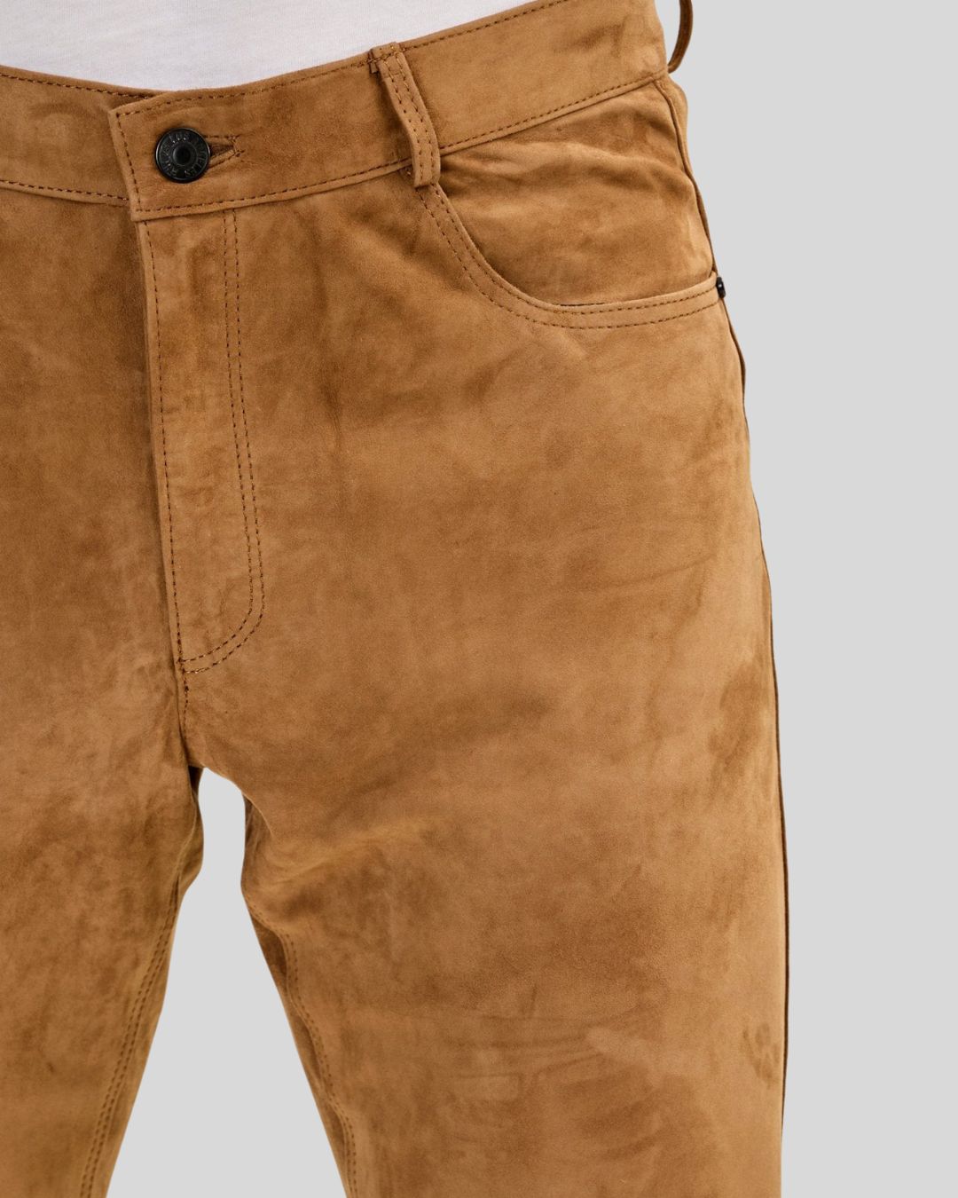 close-up detail of suede pants texture and stitching