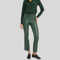 styled front pose in women's green leather pants