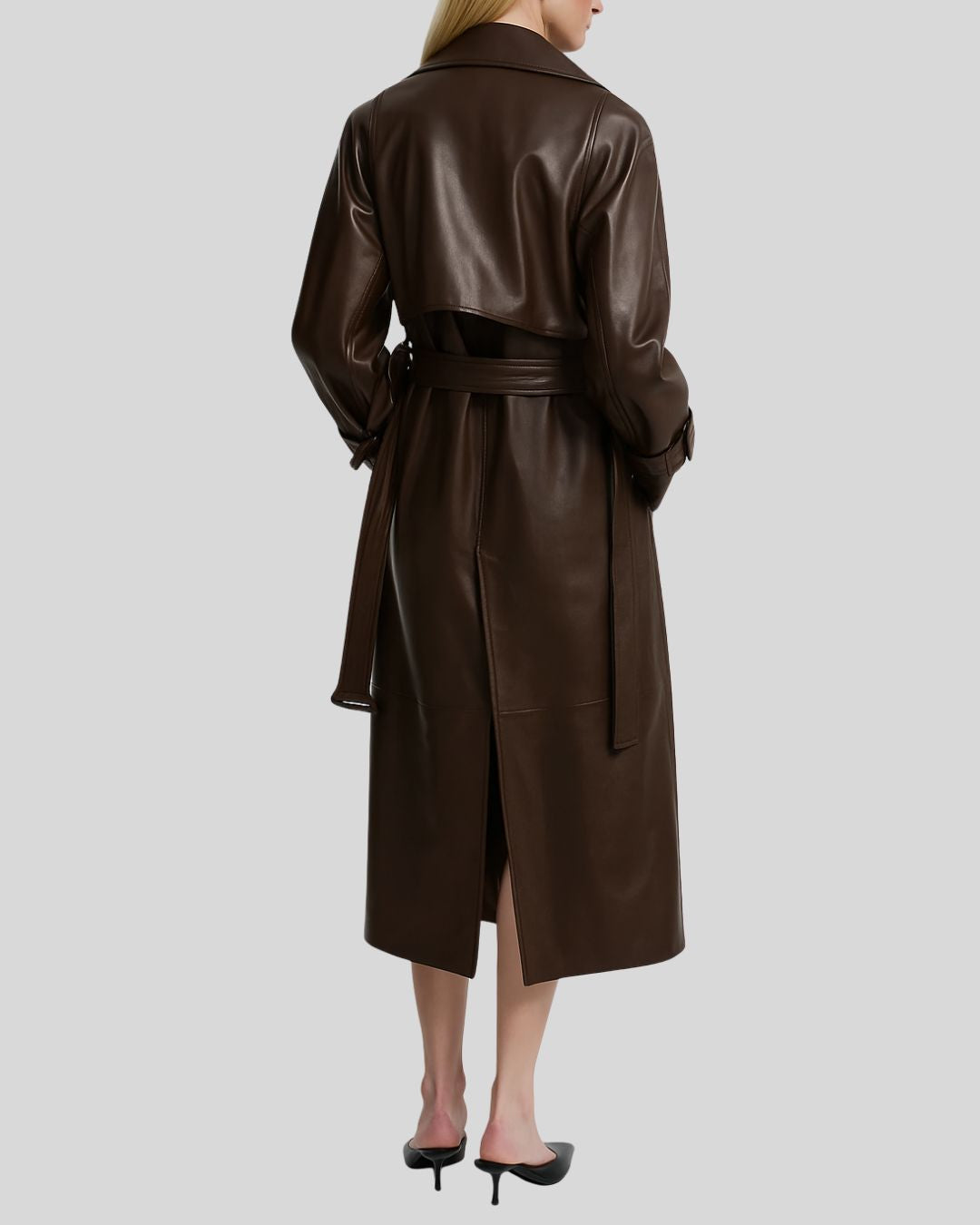 Back view of women’s brown leather trench coat with belt and center vent