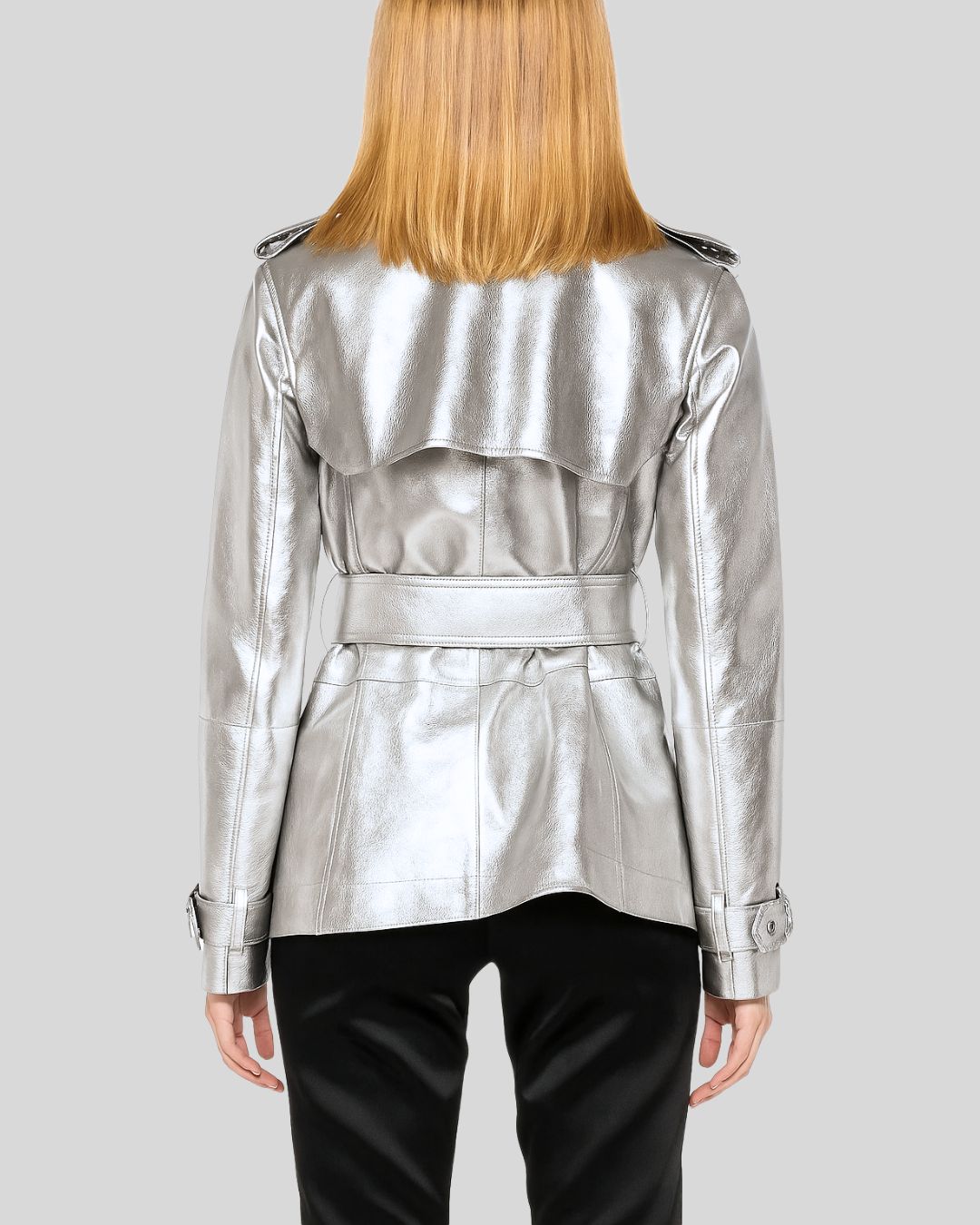 Back view of women’s metallic silver leather trench coat with belt